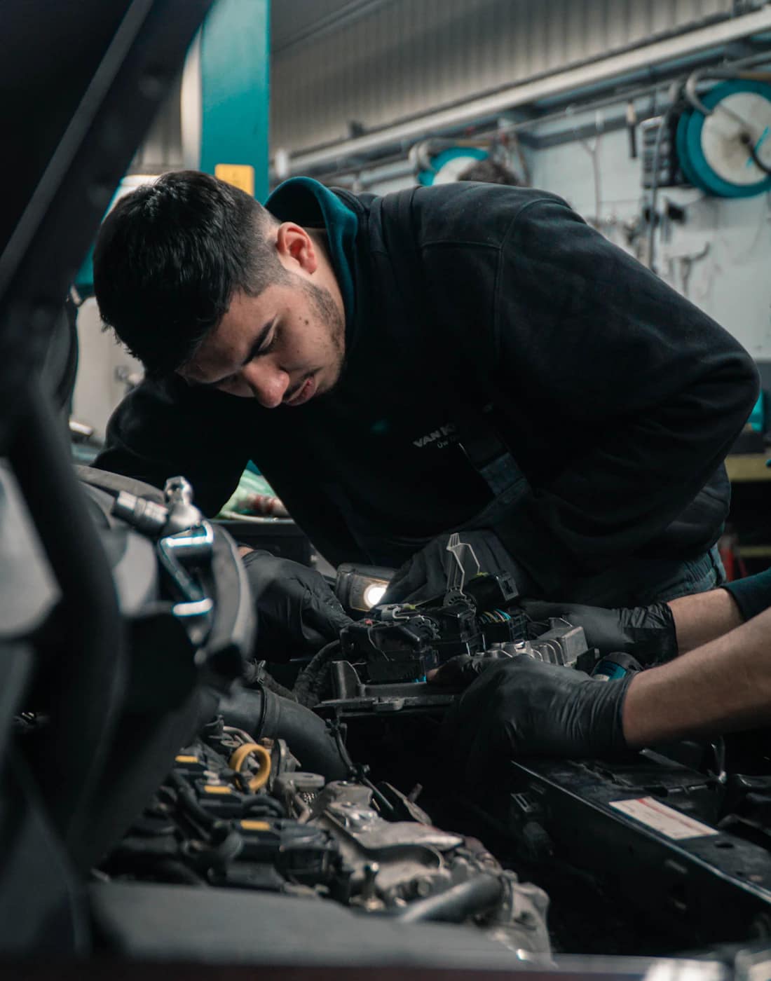 Mechanic at work under the hood at Janis Garage